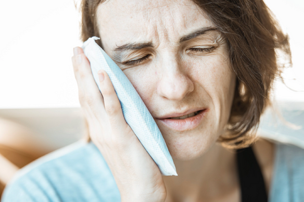 woman with toothache emergency dental visit