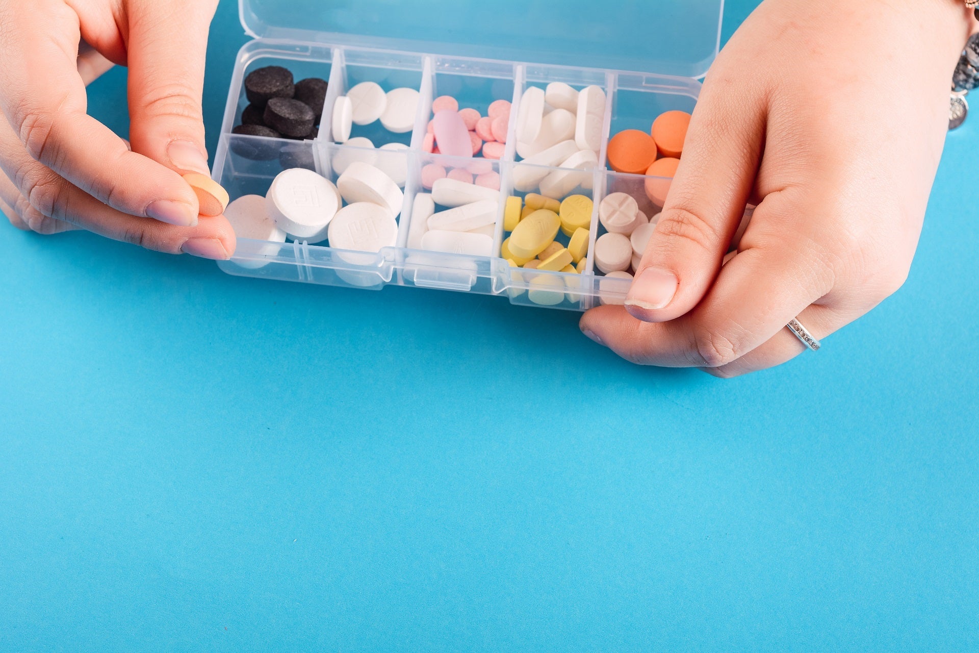 person holding medication divider