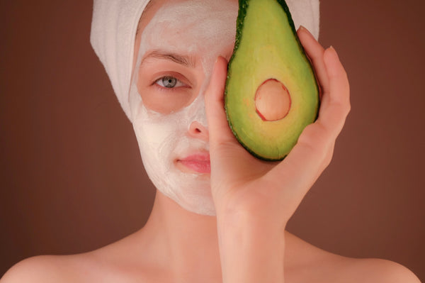 woman using avocado oil for skin care