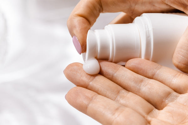 woman applying hand cream for beauty self-care