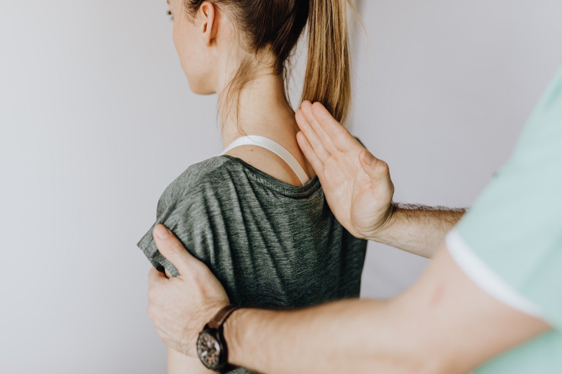chiropractor adjusting woman's back