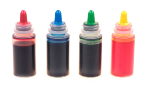 bottles of red, blue, green and yellow liquid food coloring dangerous food additives