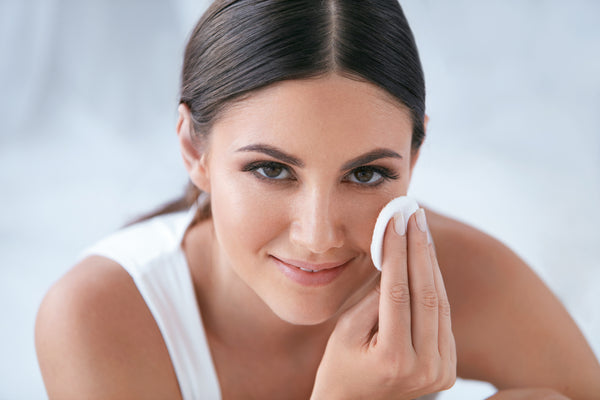 woman using exfoliators for face and body
