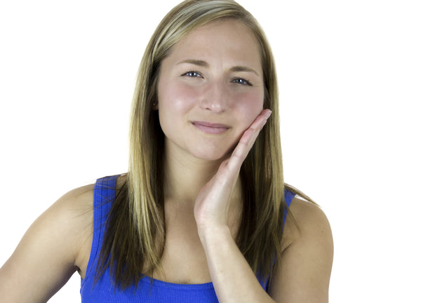girl smiling after doing exercises to relax jaw and alleviate TMJ