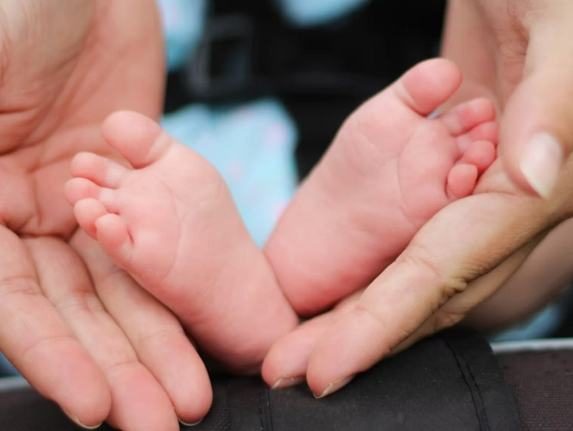 hands holding baby feet