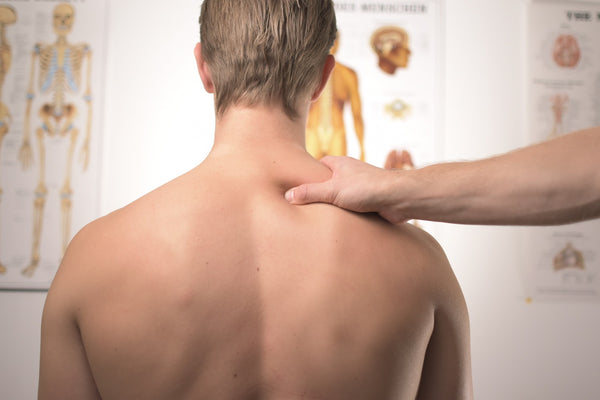 soothing the headache of man by massaging temples and neck