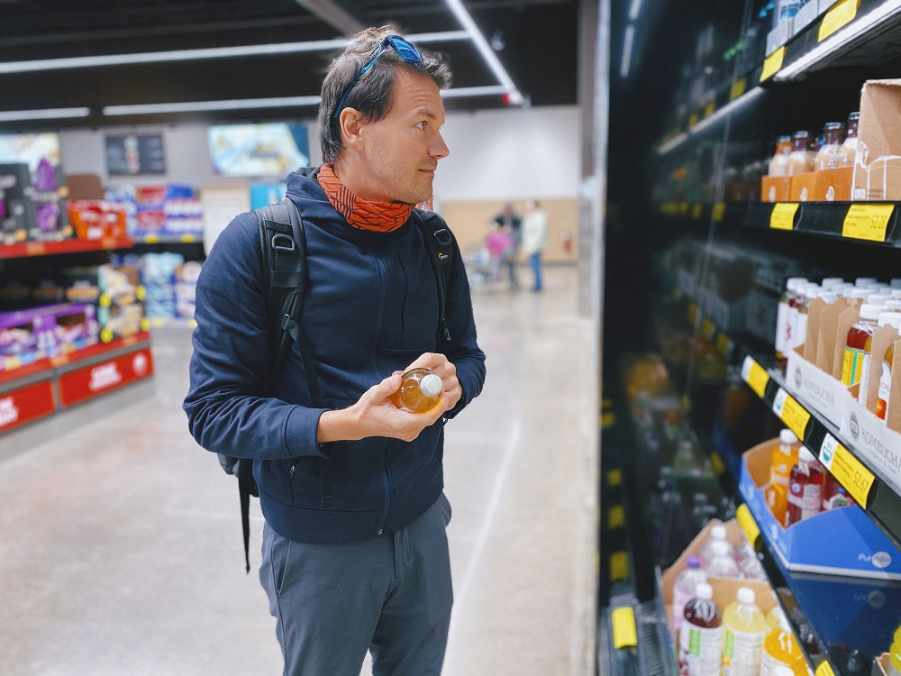 man at grocery store selecting healthy food