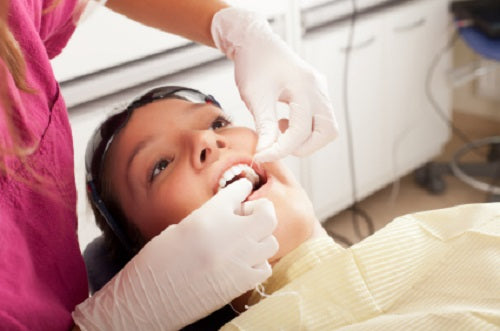 woman doing dental checkup to prevent gum disease