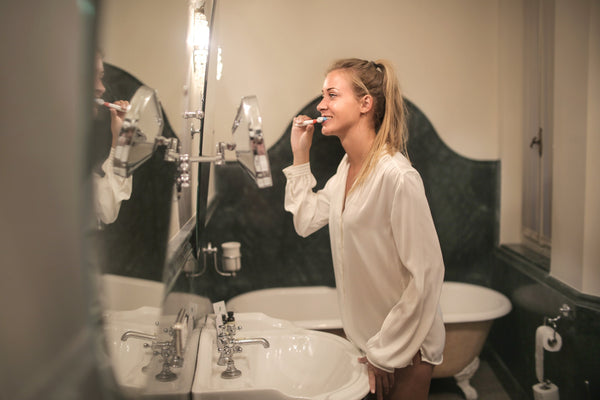 woman brushing teeth best dental habits