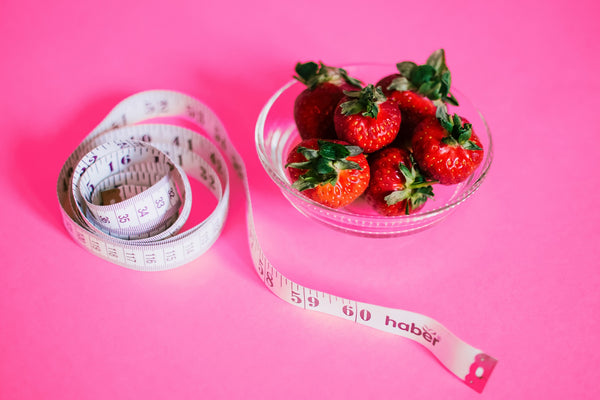 strawberries and measuring tape dietitian signs
