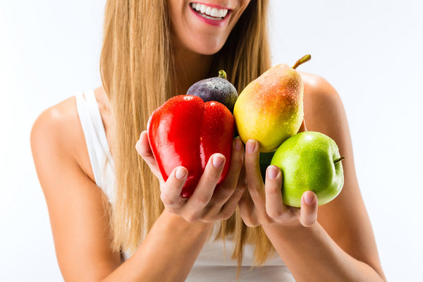 woman eating fruits and vegetables for healthy teeth