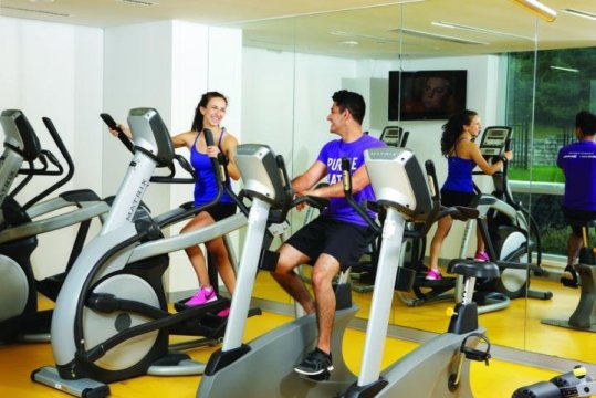 couple working out on exercise bikes