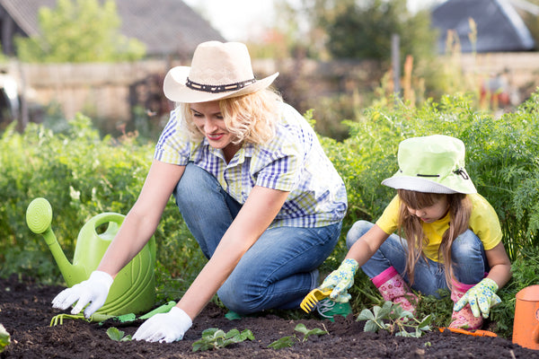 woman and girl gardening with gloves to prevent skin problems