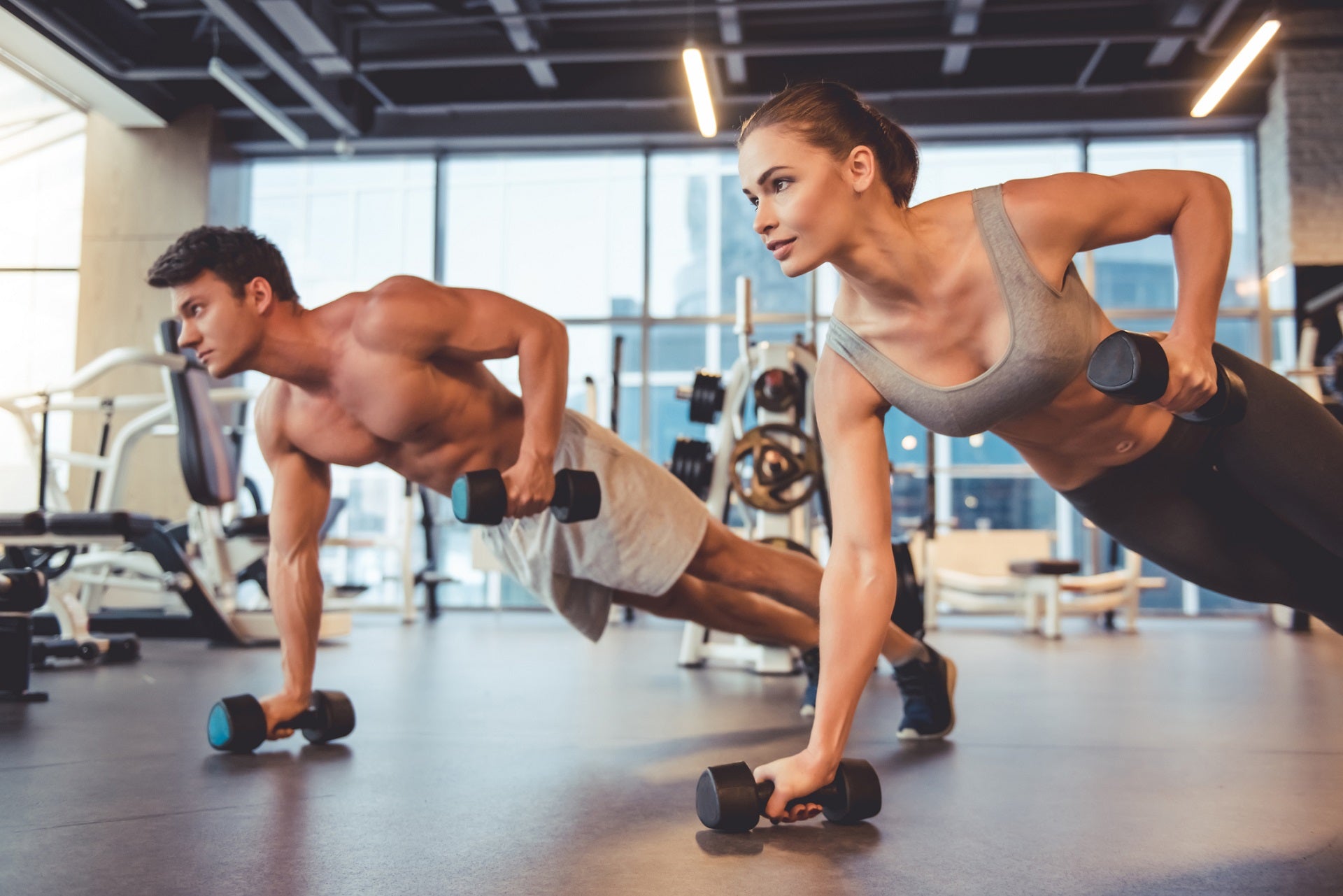 man and woman exercising in gym