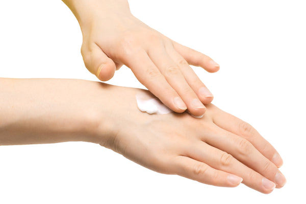 hand applying skin care moisturizer