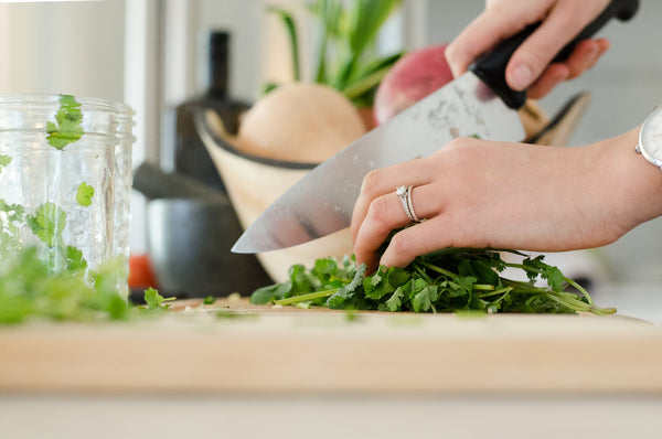person chopping vegetables to help improve sleep naturally