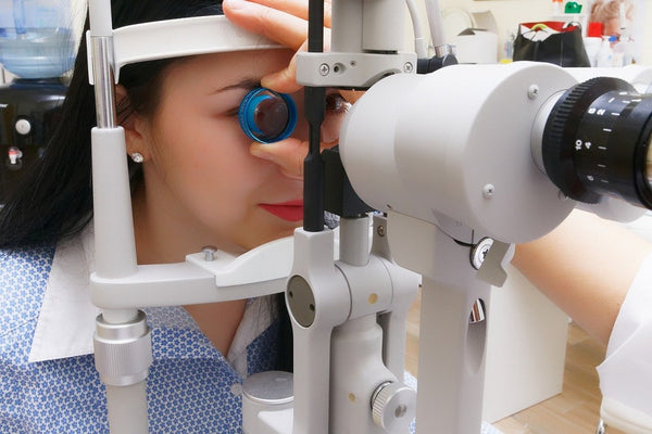 woman getting eye check up preparing for lasik surgery