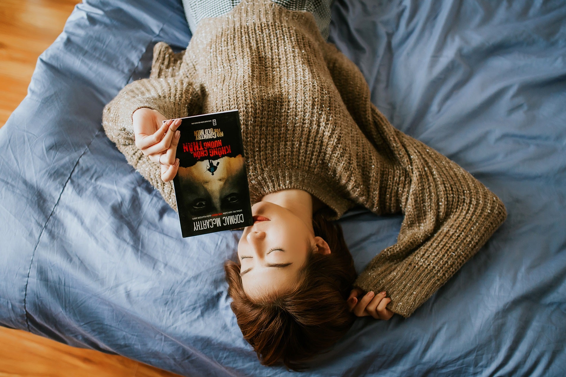 woman reading in bed for restful sleep