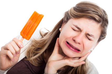 girl with sensitive teeth eating a popsicle