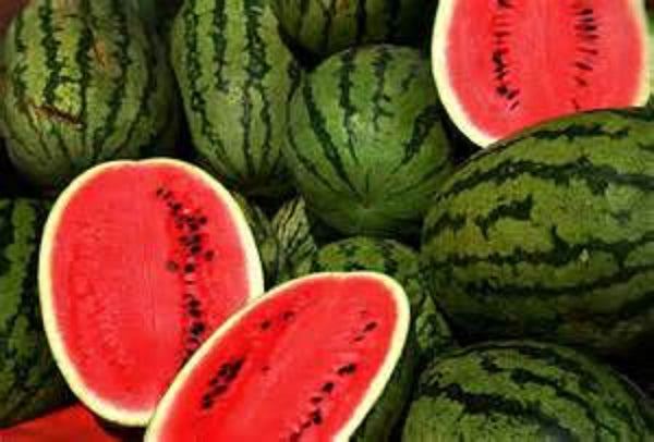lots of watermelons and a few sliced making it a perfect snack